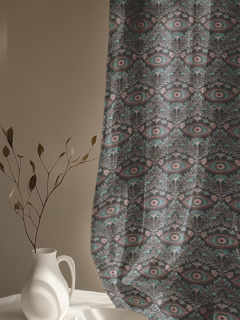 Sheer curtain panel featuring repeating sage green and blush pink evil eye motif surrounded by botanical elements on dark gray background. Linen-textured polyester fabric allows filtered light while providing elegant window covering with protective symbolism for Victorian or gothic interiors.